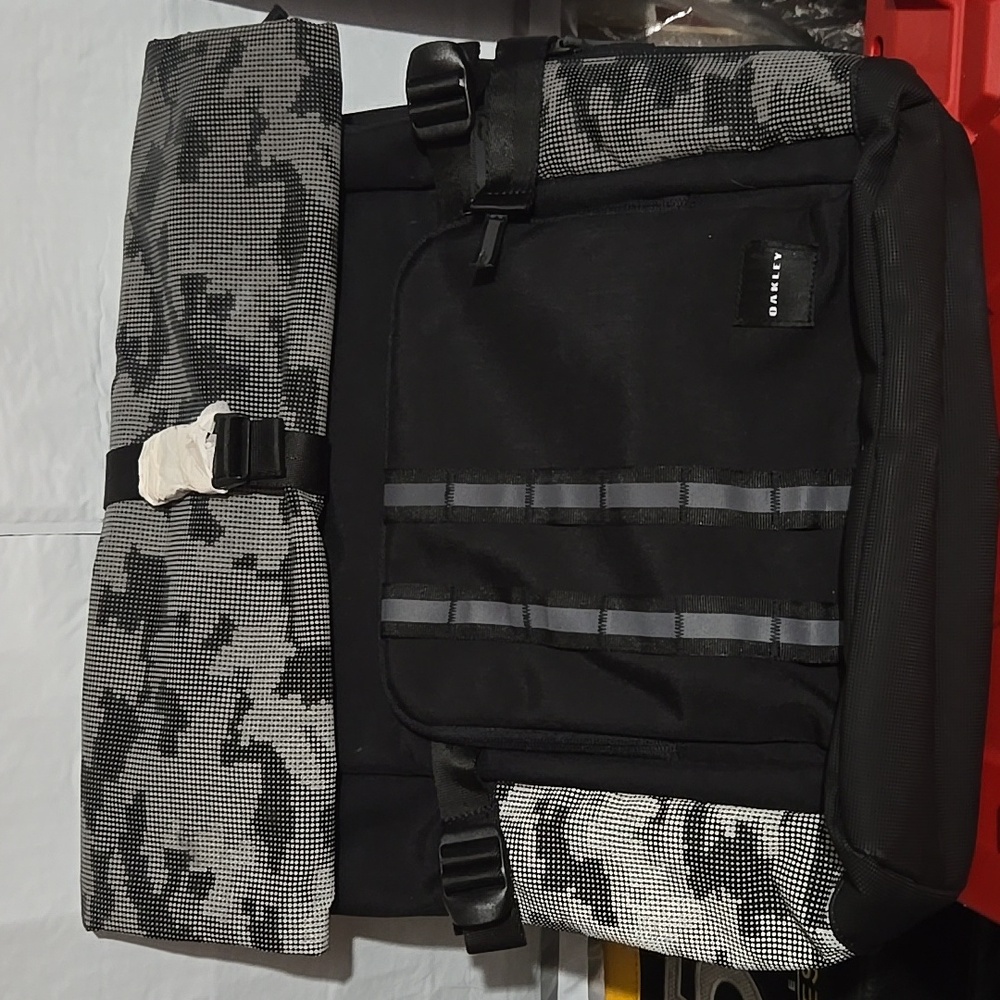 OAKLEY BACKPACK WITH A ROLL TOP ZIPPER CLOSURE - BLACK AND GREY CAMO